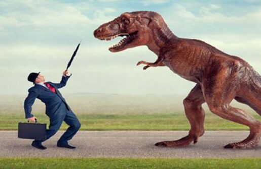 An image of a businessman confronting a T-Rex.