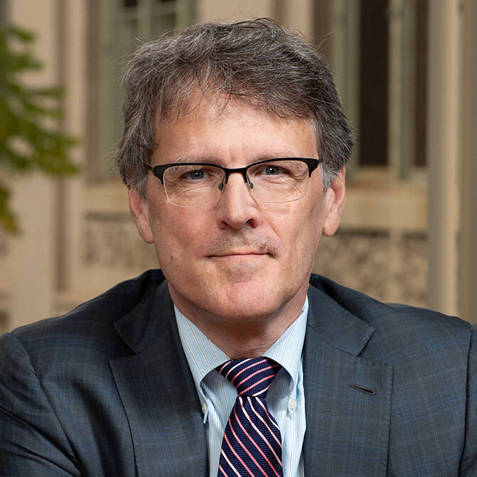 Man wearing a suit with striped tie.