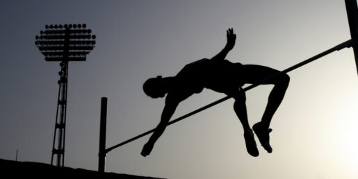 An image showing a body completing a high jump.