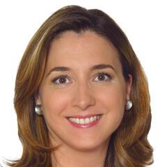 Woman with long brown hair and pearl earrings.