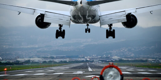 Image of a plane about to touch down on the tarmac.