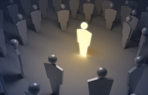 FIgure of person glowing while surrounded by other figures of people