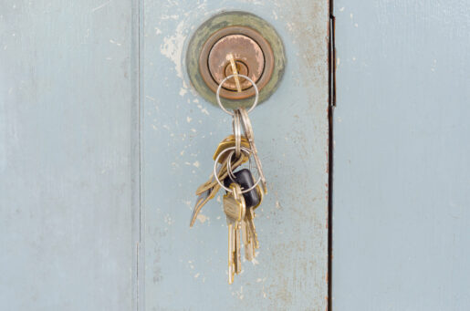 A key sits in a door.