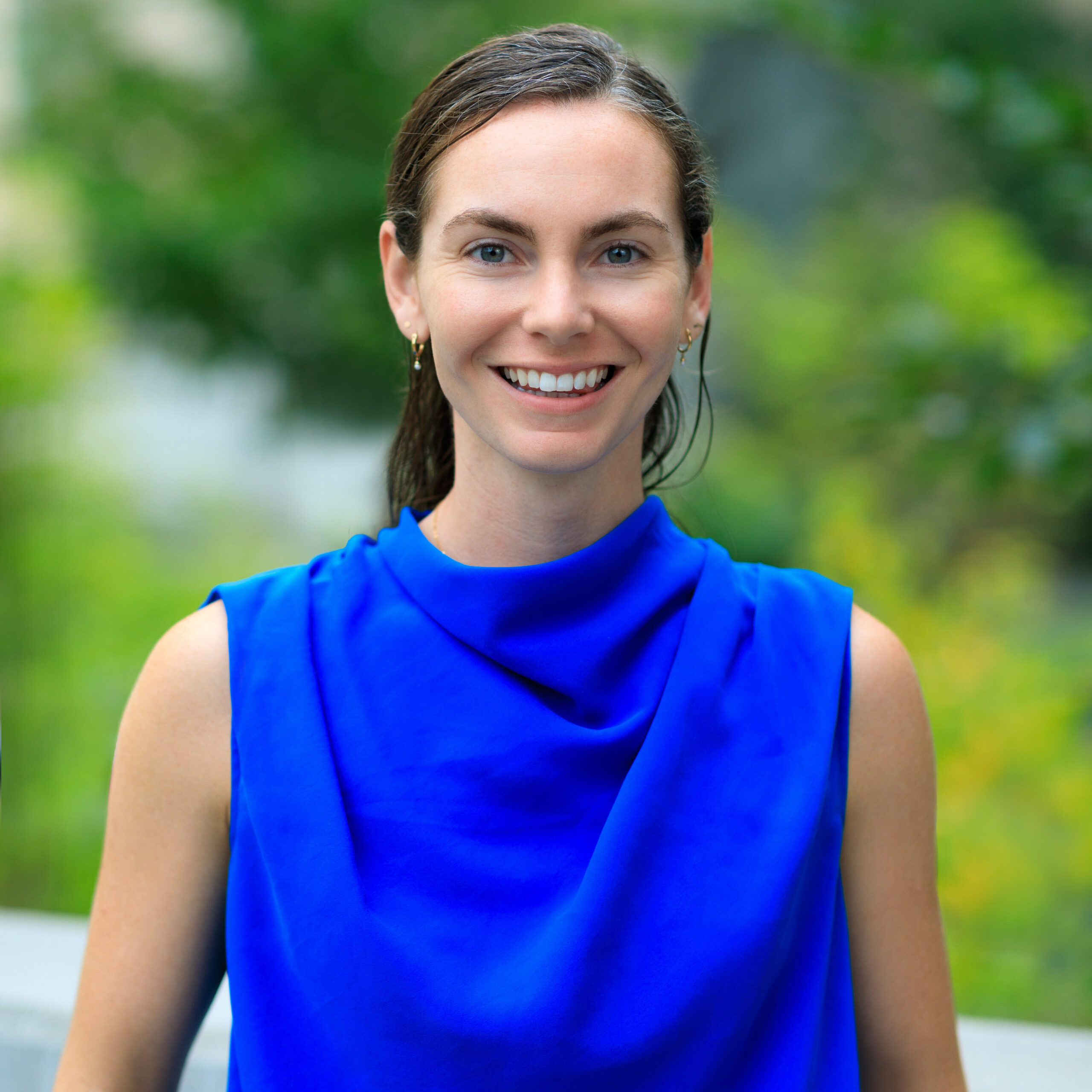 Kelly Murphy smiles outside wearing a blue shirt.