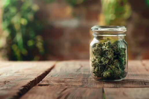 Cannabis in a jar on a table.