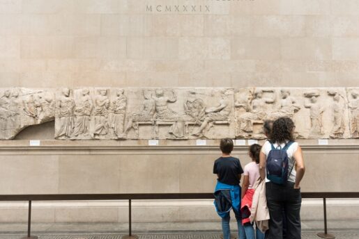 a family looks at the Elgin marbles in the British Museum.