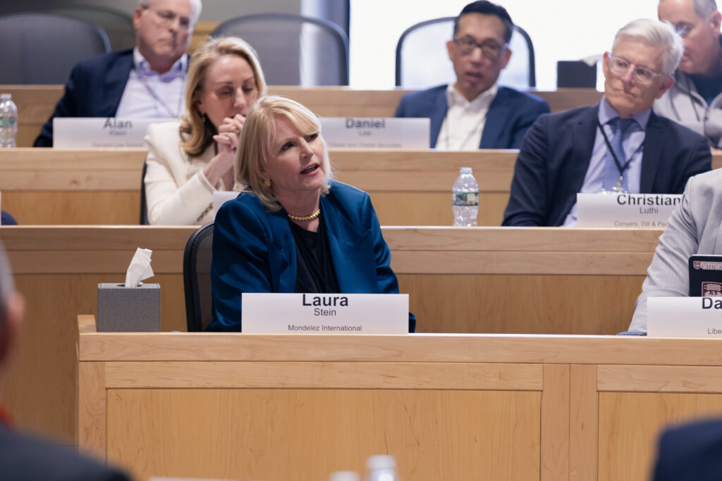 A woman speaks in a classroom while others listen.