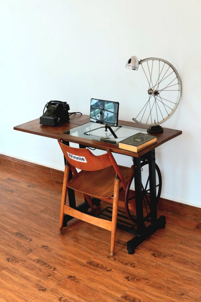 Gerald Abila built Winnie's desk to remind his team of the potential promise and hazards of AI for law. On the table also sits the collected works of Khalil Gibran as well as an old magneto phone from the 1930s they have nicknamed "Nebuchadnezzar” after the main ship in the Matrix movie franchise.